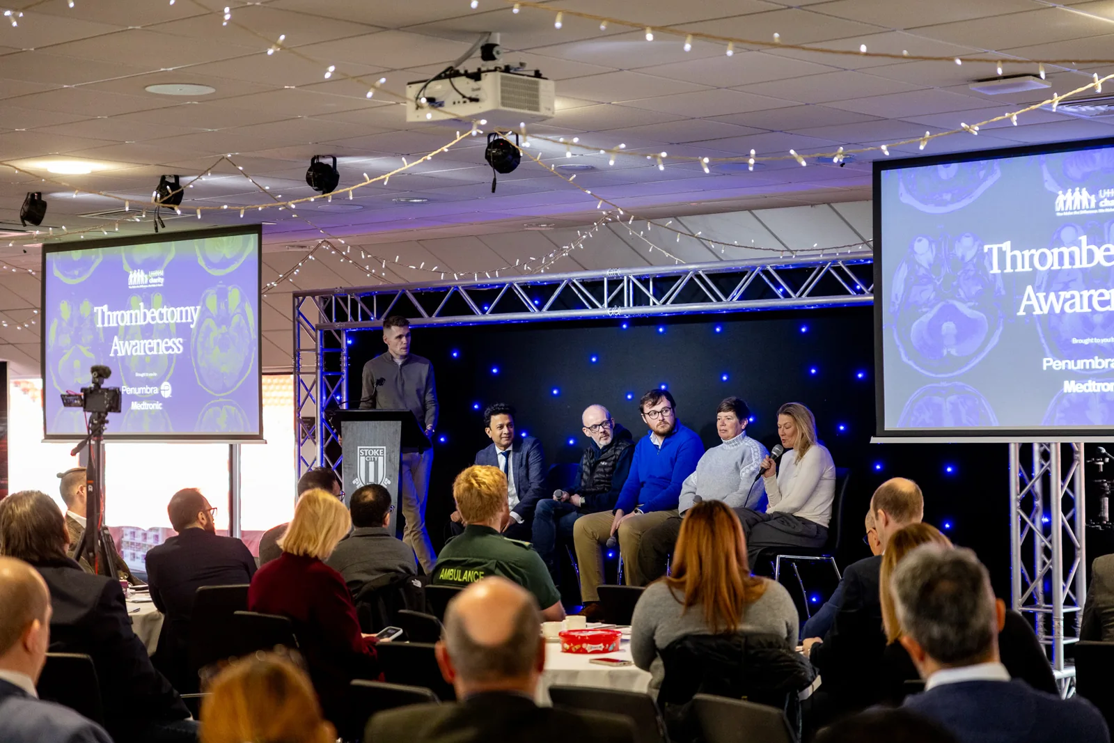 Awards presentation on a conference stage with screens and lighting