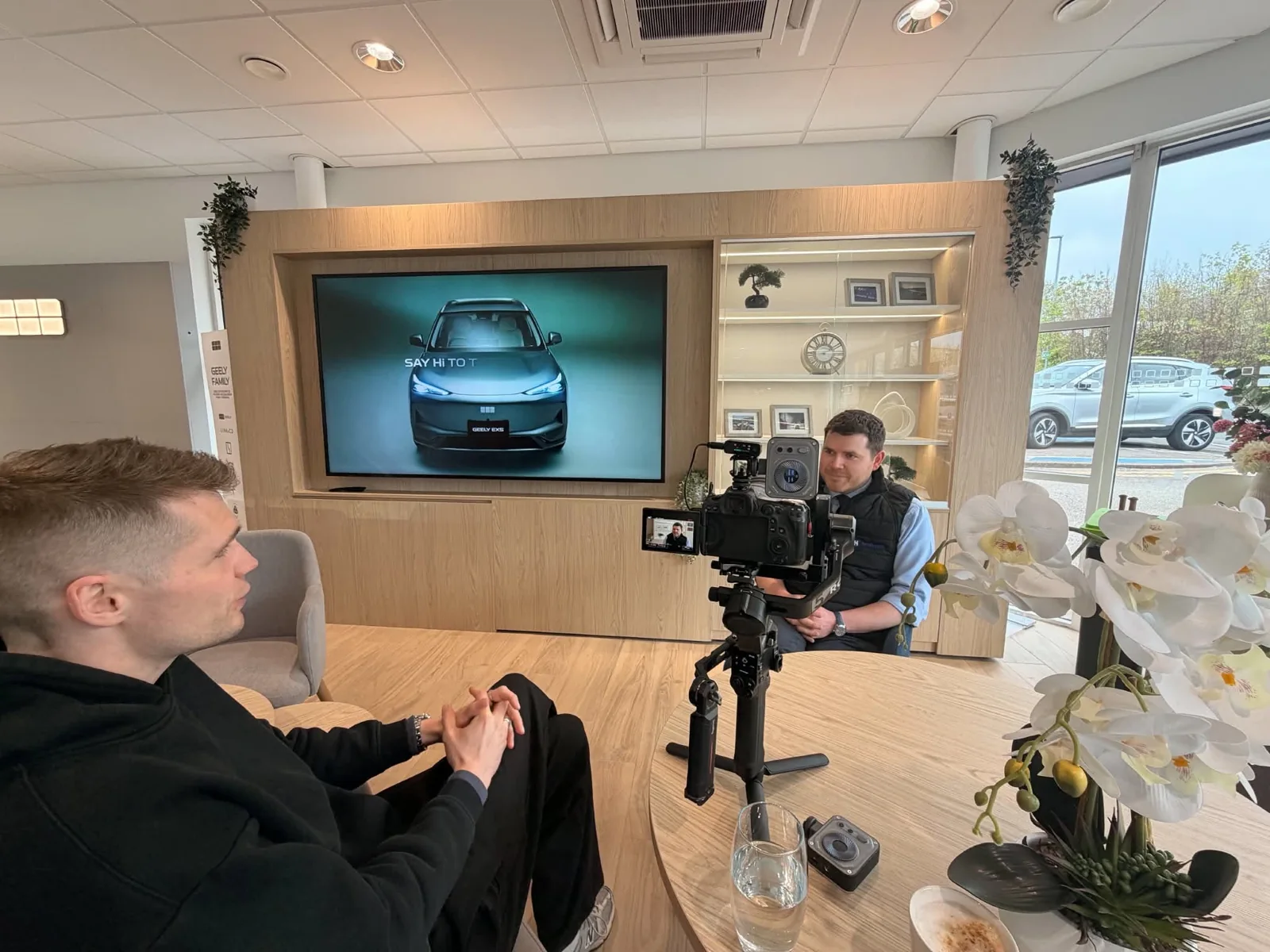 PREM camera operator filming a Geely interview on location