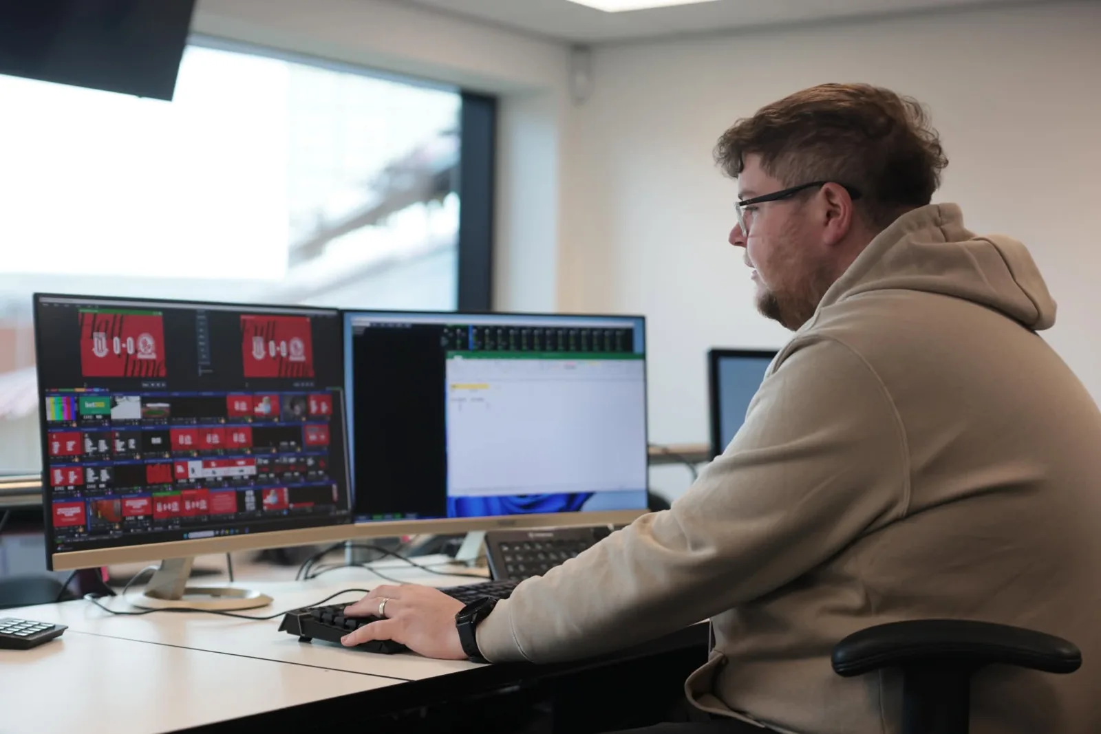 PREM operator preparing live screen content at a production workstation